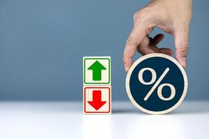 Percent with arrow up, down icon on wooden cube. interest rate change, percentage rate is falling and rising. business concept with copy space photo