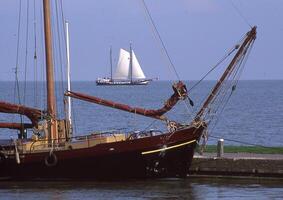 a sailboat is docked at a dock photo