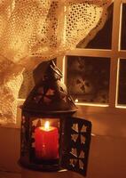 a candle is sitting on a table next to a window photo