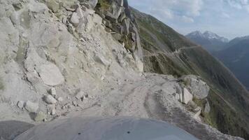 Car driving through a narrow mountain road 4k background video