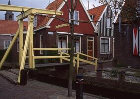 a yellow wooden bridge photo