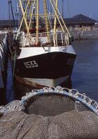 a boat is docked at a dock photo