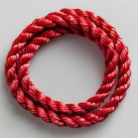 Red rope isolated on white background with shadow. Red cord rope photo