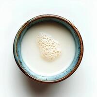 Milk in cup isolated on white background with shadow. Milk in blue cup full of calcium top view photo