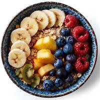 Oatmeal bowl isolated on white background with shadow. Oatmeal with variety of fruits top view. Oatmeal with strawberries, bananas, blueberries photo