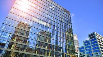 Glass building with transparent facade of the building and blue sky. Structural glass wall reflecting blue sky. photo