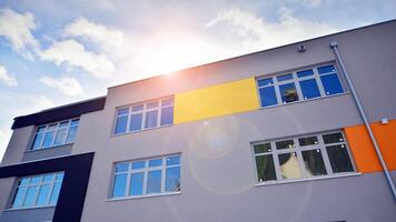 Multi-colored facades of the school with white window frames. photo