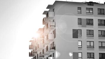 Fragment of the building's facade with windows and balconies. Modern apartment buildings on a sunny day. Facade of a modern residential building. Black and white. photo