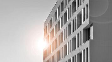 Fragment of the building's facade with windows and balconies. Modern apartment buildings on a sunny day. Facade of a modern residential building. Black and white. photo