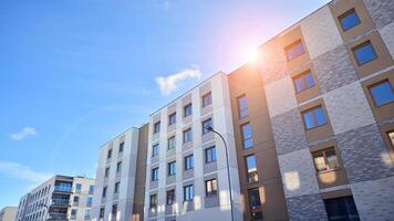 Modern apartment building in sunny day. Exterior, residential house facade. Residential area with modern, new and stylish living block of flats. photo