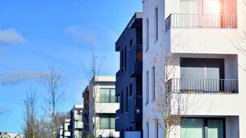 Modern apartment building in sunny day. Exterior, residential house facade. Residential area with modern, new and stylish living block of flats. photo