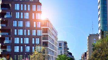 Eco architecture. Green tree and new residential building. Harmony of nature and modernity. Modern apartment building with new apartments in a green residential area. photo