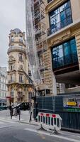 Urban construction scene with scaffolding on classic French architecture in Paris, France, emphasizing renewal and city maintenance, taken on April 14, 2024 photo