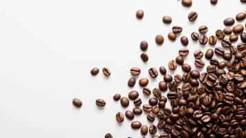 Top view of scattered coffee beans, isolated on a white background with space for text photo