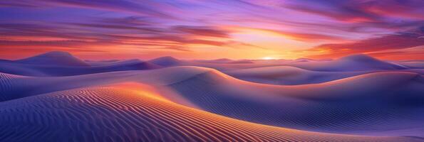 Sunrise paints unusual fractal patterns on undulating desert sand dunes with a vibrant orange and purple gradient sky as backdrop photo