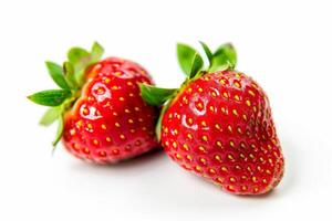 couple of vibrant red strawberries isolated on a white background photo