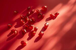 scattered pomegranate seeds isolated on a red gradient background photo