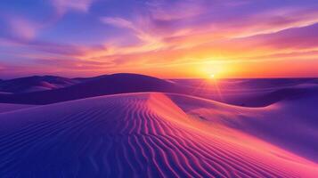 Sunrise paints unusual fractal patterns on undulating desert sand dunes with a vibrant orange and purple gradient sky as backdrop photo