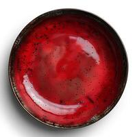 Red ceramic plate isolated on white background with shadow. Red plate with texture top view photo