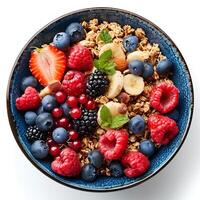 Oatmeal bowl isolated on white background with shadow. Oatmeal with variety of fruits top view. Oatmeal with strawberries, bananas, blueberries photo