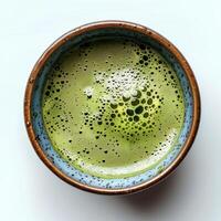 Green matcha tea in cup isolated on white background. Healthy green tea in blue cup to promote better gut health photo