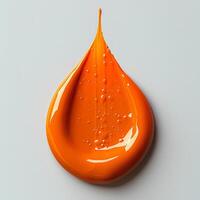 orange paint drop isolated on white background with shadow. orange paint explosion photo
