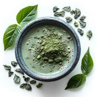 Green matcha tea in cup isolated on white background. Healthy green tea in blue cup to promote better gut health photo