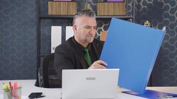 Successful businessman working happily on paperwork files. video