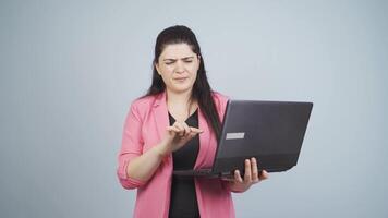 Business woman looking at laptop with scared expression. video