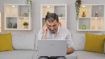 Man looking at laptop is thoughtful. video