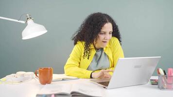 The young woman who likes the application on the laptop is happy. video