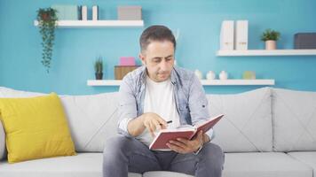 Man with notebook thinks and takes notes. video