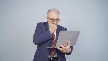 Businessman looking at laptop with excitement. video