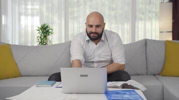 Home office worker man reading good news and feeling happy. video