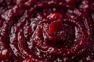 Overhead view of cranberry sauce swirling in a bowl, rich texture and color photo