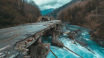 collapsed bridge over a river, aftermath of a natural disaster photo