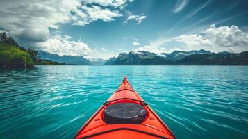 single red kayak on a turquoise lake, distant mountains, adventure theme photo