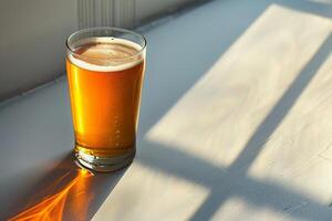 Shadow play with a beer glass, creating an abstract form on a brightly lit surface, minimal and artistic photo
