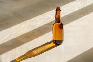 Elegant beer bottle casting a long shadow on a smooth, light surface, minimalist aesthetic photo