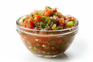 Scoop of chunky salsa in a glass bowl, colorful with red tomatoes and green peppers, isolated on white photo