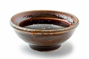 Shiny teriyaki sauce in a traditional ceramic dish, glossy and sticky, isolated on a white background photo