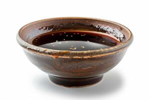 Shiny teriyaki sauce in a traditional ceramic dish, glossy and sticky, isolated on a white background photo