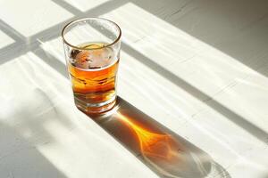 Shadow play with a beer glass, creating an abstract form on a brightly lit surface, minimal and artistic photo