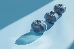 Blueberry shadow on a gradient light blue background, artistic minimalism photo
