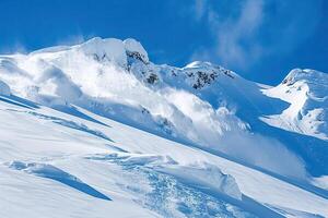 Descent of an huge avalanche from the mountain, winter nature landscape photo