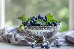 blueberries in a silver bowl with mint leaves, elegant, simple composition photo