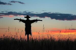 Silhouette of a scarecrow in a barren field at dusk, aftermath of a heatwave, eerie calm photo