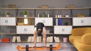 Young man exercising at home. video