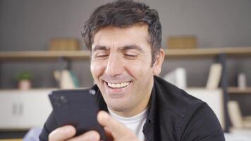 Happy man using phone, message. video