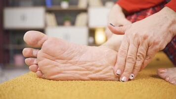 Woman applies cream to the heel of foot video